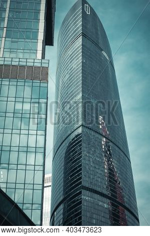 Moscow, Russia - 15.01.2021: Bottom View Of Glass Skyscraper On The Background Of Morning Sky With C