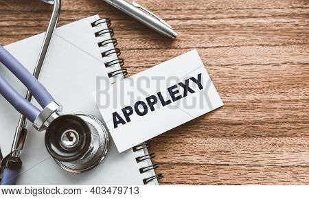 A Card With Text Apoplexy On Wooden Doctor's Table.