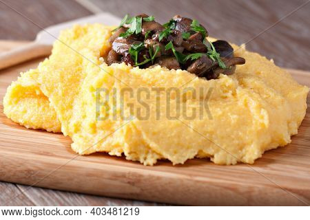 Polenta With Mushroom. Traditional Corn Food In The Plate.