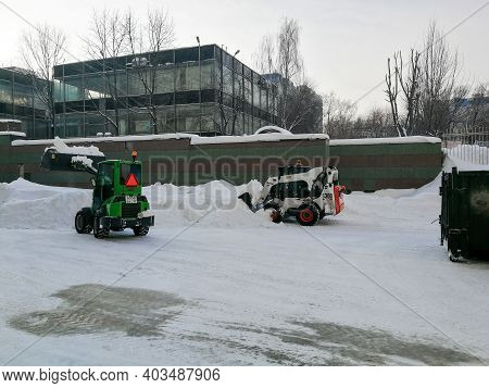 Moscow. Russia. January 15, 2021. Small Front-end Loaders Clear Snow From The Street And Load Into A