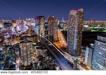 Tokyo, Japan dense urban cityscape overlooking Minato Ward at night.