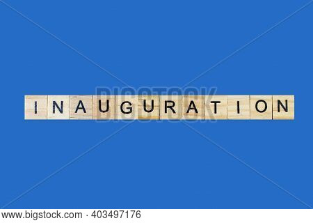 Inauguration . English Word On Blue Background Composed From Letters On Wooden Cubes. Learning Engli