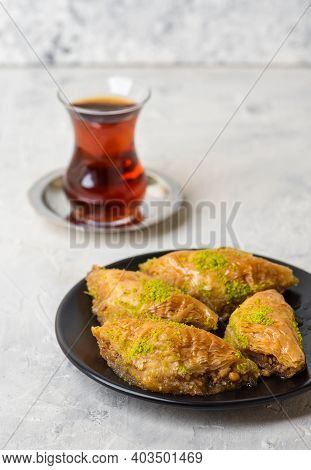 Baklava Or Sobiyet. Traditional Turkish Desserts Baklava With Turkish Tea. Crispy Pistachio Baklava 