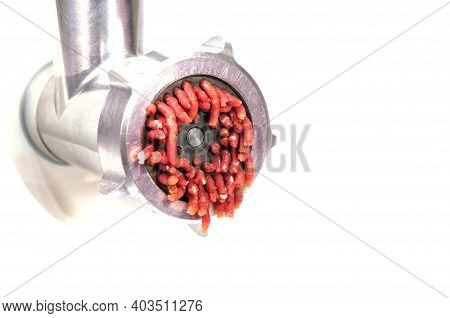 Electric Meat Grinder Grinds Raw Red Meat Into Mince. High Quality Photo