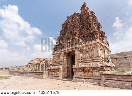 Hampi, Karnataka, India - November 5, 2013: Vijaya Vitthala Temple. Wider Views On Red Stone Gopuram
