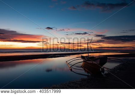 Boat sunset blue skies sea sikly waters