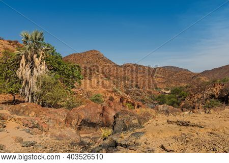 Landscape On The Banks Of The Kunene River, The Border River Between Namibia And Angola