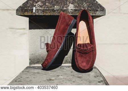 Brown Leather Moccasins. Photo On The Street On The Wall. Trendy Brown Loafers.