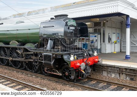 Queensferry, Scotland - May 20, 2018: Flying Scotsman Steam Train Passing Station Dalmeny In Queensf