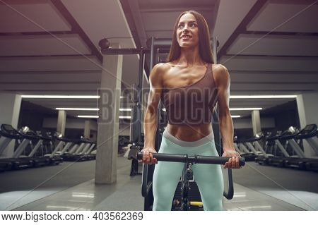 Fitness Woman Pumping Up Biceps Muscles Workout Fitness And Bodybuilding Concept Gym Background Exer