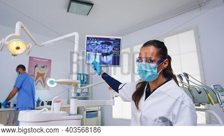 Dentist Doctor And Patient Looking At Digital Teeh X-ray In Dental Office, Person Pov. Stomatology W