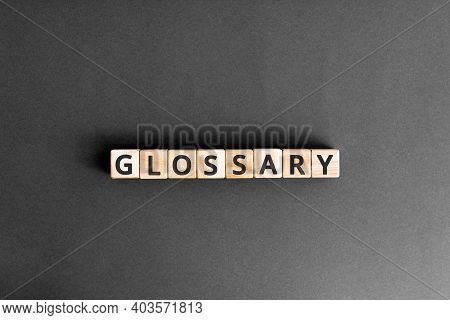 Glossary - Word From Wooden Blocks With Letters, Alphabetical List With Words Meanings Dictionary Gl