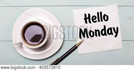 On A Light Blue Wooden Tray, There Is A White Cup Of Coffee, A Handle And A Napkin That Says Hello M