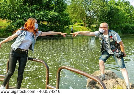 Minsk Belarus - August 27 2020: Woman And Man Are Trying To Touch Each Other Across The Distance. Re