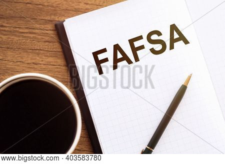 Fafsa Text On Notepad On Wooden Desk.