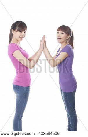 Portrait Of Two Female Friends Claping High Quality Photo