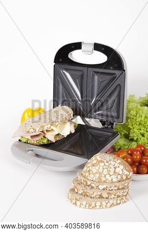 Sandwich Maker Gray With Food; Photo On White Background.