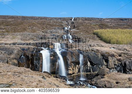 Waterfall Range In The Hills Of Fljotsdalur Valley In East Iceland On A Sunny Day