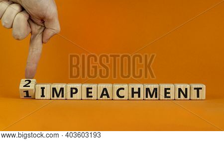 Second Impeachment Symbol. Businessman Turns Wooden Cubes And Changes Words '1 Impeachment' To '2 Im