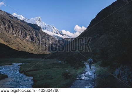 Hiker On The Trail To Lagoon 69 With Snowy Peaks Of Chakrarahu In The Background, Peru.