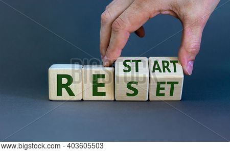 Reset And Restart Symbol. Businessman Hand Turns Cubes And Changes The Word 'reset' To 'restart'. Be