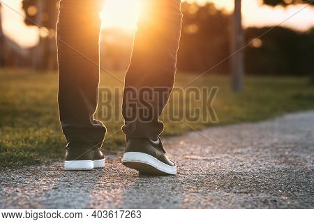 Man Walking Outdoors In The Park At Sunset. Man On His Way To A New Better Life. The Way Forward. Ne