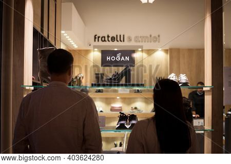 Belgrade, Serbia - September 18, 2020: Clients Looking At The Window Of A Hogan Shoes Store With A W