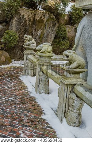 Stone Carved Dragon,rabbit And Bear That Represents The Chinese Horoscope, On Concrete Fence.