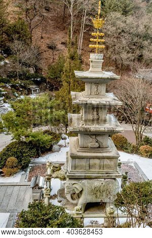 Four Story Stone Carved Pagoda On Plinth Of Three Elephants At Buddhist Temple.