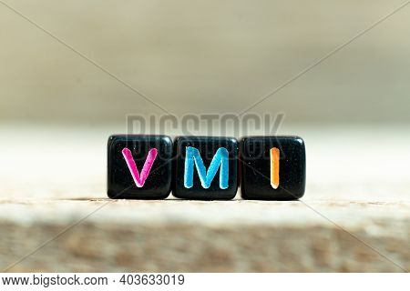 Black Color Block With Word Vmi (abbreviation Of Vendor Managed Inventory) On Wood Background