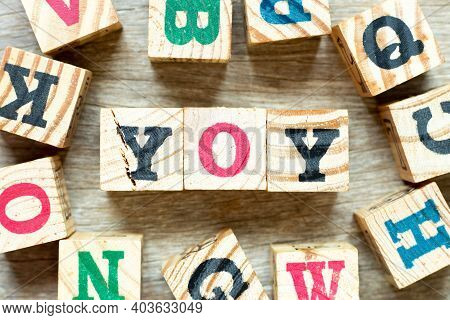 Alphabet Letter Block In Word Yoy (abbreviation Of Year Over Year) With Another On Wood Background