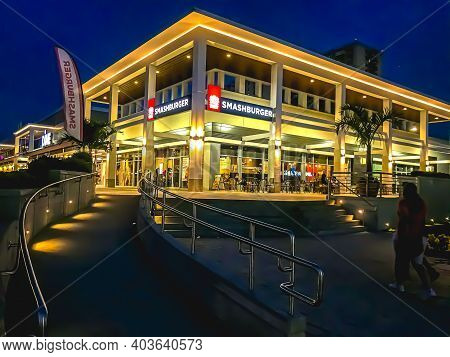 Smash Burger Fast Food Restaurant Exterior At Night With Lights On In The Bronx From A Wide, Diagona