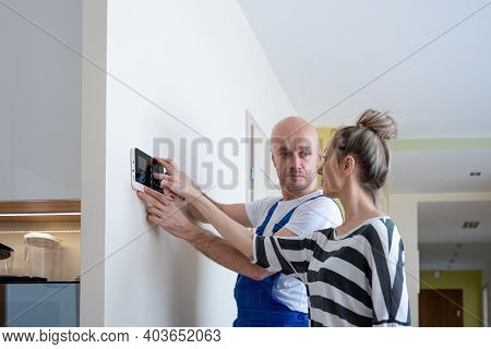 The Alarm Fitter Installs An Alarm At Home. Protection Against Theft.