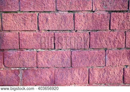 The Texture Of An Old Red Brick Stone Wall With Scuffs And Scratches, Painted With Pink Paint
