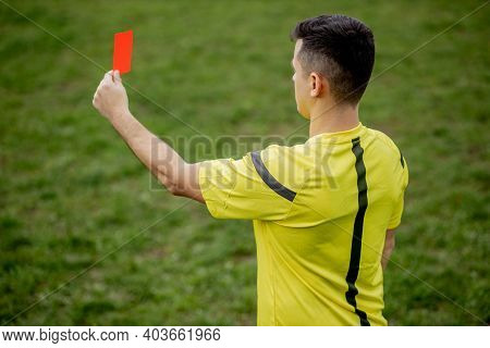 Referee Showing A Red Card To A Displeased Football Or Soccer Player While Gaming. Concept Of Sport,