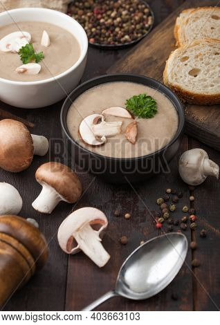 Ceramic Bowl Plates Of Creamy Chestnut Champignon Mushroom Soup With Spoon, Pepper And Kitchen Cloth