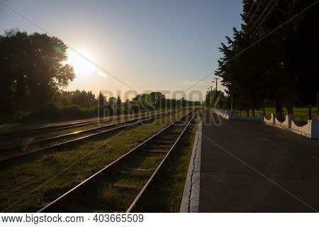 Railway Station Against Beautiful Sky At Sunset. Industrial Landscape With Railroad, Colorful Sky Wi