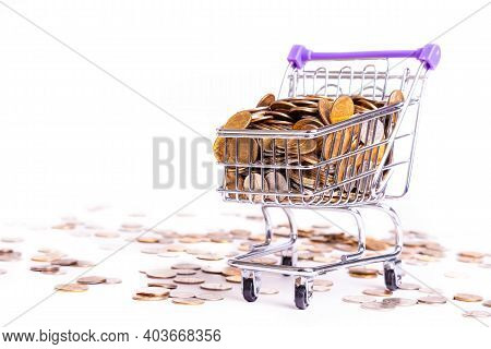 Supermarket Metal Basket On Wheels With Metal Money Coins On White Background - Multicurrency Basket