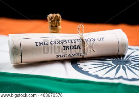 Indian Constitution Or Bharatiya Savidhana Preamble Old Scattered Text Paper Placed On Indian Flag -