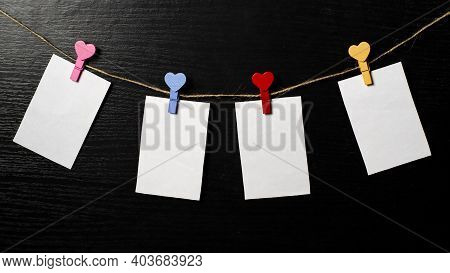 Photos Are Held With Heart-shaped Clothespins On A Rope. Copspace. Valentines Day.