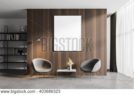 Interior Of Minimalistic Living Room With Wooden Walls, Concrete Floor, Two Armchairs Standing Near 