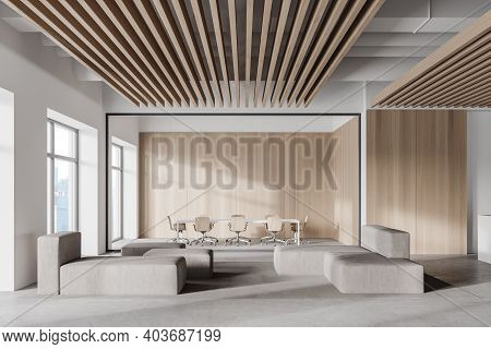 Interior Of Modern Office Waiting Room With White And Wooden Walls, Concrete Floor, Gray Sofas And R