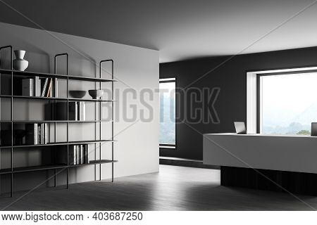 Corner Of Minimalistic Office With Gray Walls, Concrete Floor, White Reception Desk And A Bookcase. 