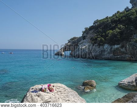 Gulf Of Orosei, Sardinia, Italy, September 8, 2020: A View Of Yopung Woman Sunbathing At Cala Golori