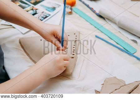 Women's Hands Knead Clay, Drawing Elements Of The Product. Production Of Ceramic Products At The Mas