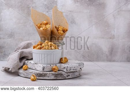 Salted Caramel Popcorn In Bowl On Light Background