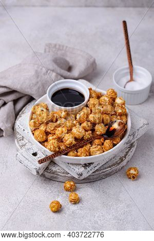 Salted Caramel Popcorn In Bowl On Light Background