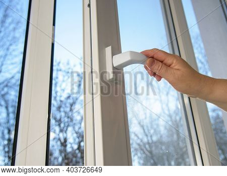 Hand Opens Vinyl Plastic Window On Blue Sky Winter Background. Oneped Window.