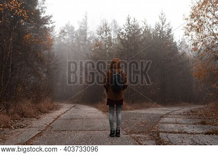 Girl With Backpack From Behind At The Crossroad In The Wood