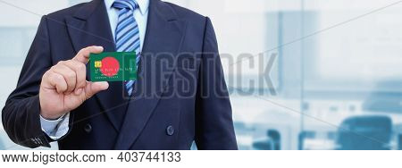 Cropped Image Of Businessman Holding Plastic Credit Card With Printed Flag Of Bangladesh. Background